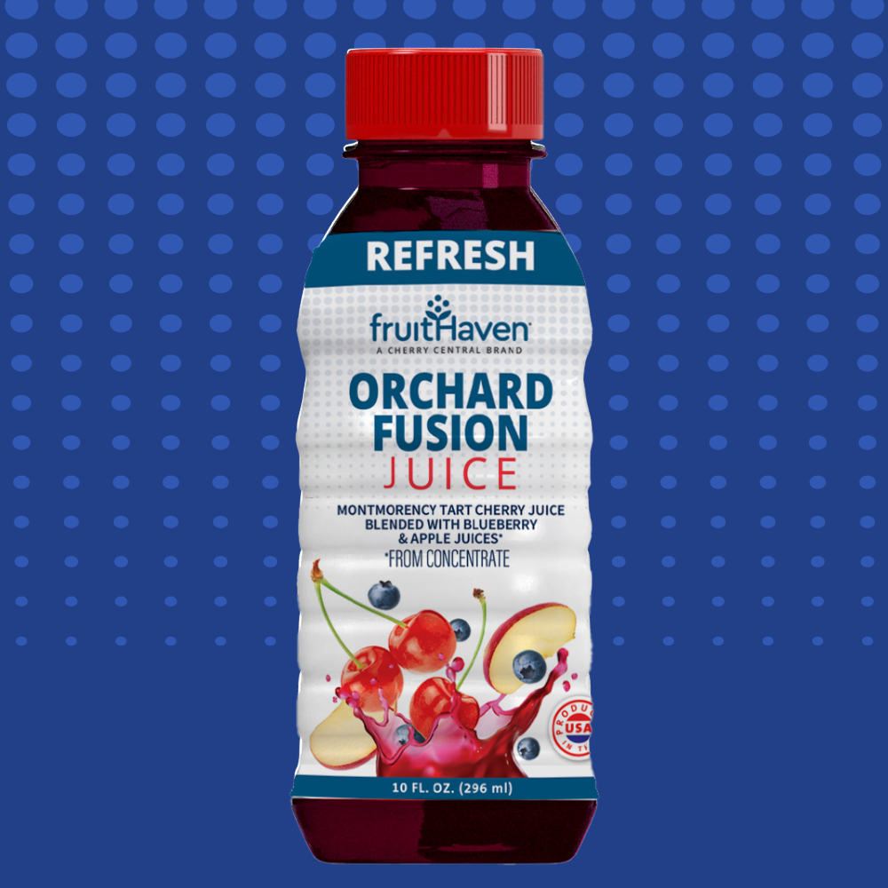 Bottle of fruitHaven Orchard Fusion Juice on a blue polka dot background